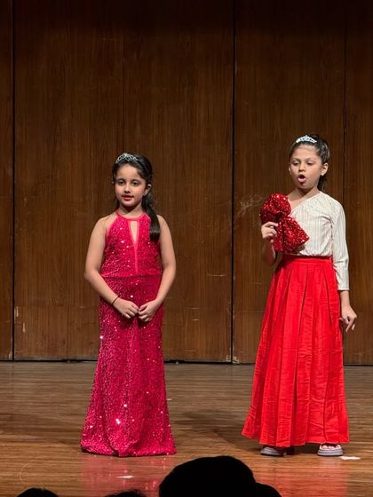A dramatic scene between two performers, using props and powerful expressions to convey their story.