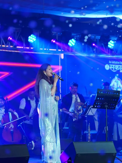 The full stage view, highlighting the grandeur of the event and the sparkling outfit.