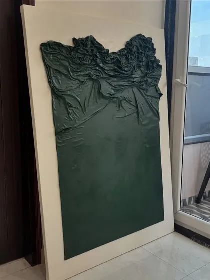 This 57" x 40" piece for a client in Gurgaon uses cloth to create a unique, flowing texture. The fabric is sculpted and painted, resulting in a piece that looks like a frozen, deep green wave.