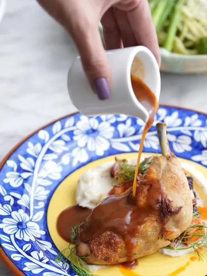 This is my Duck Confit, slow-cooked until it's perfectly tender and served on a bed of creamy mash. The rich sauce being poured over is the final touch to this classic European dish.