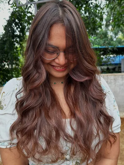 Getting ready for 'Ghar ki shaadi' (a home wedding). This client wanted a glamorous but natural look, so I gave her a rich color melt with soft waves, perfect for the occasion.