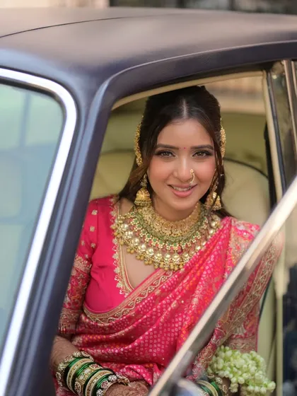 A beautiful smile from the bride. Her makeup is designed to enhance her natural happiness, with a focus on glowing skin and bright eyes.