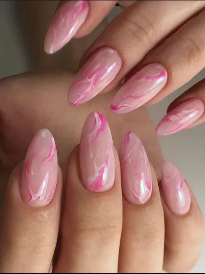 A beautiful pink quartz or marble effect on long almond nails.