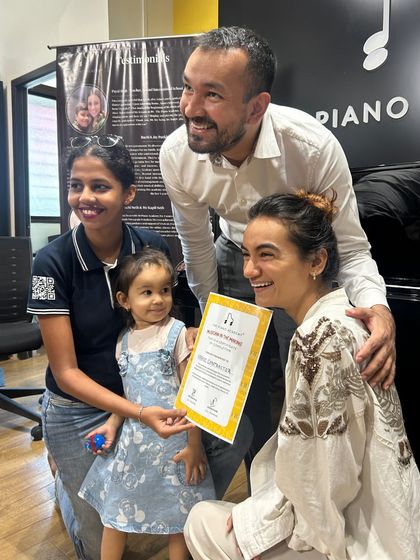 A proud moment from our 2025 music summer camp in South Mumbai. A young student receives her certificate, surrounded by her family and teachers. New enrollments for our July camp are now open.