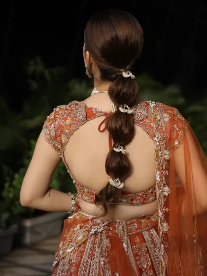 A back view of the bubble ponytail, showing the intricate ties that create the "bubble" effect.
