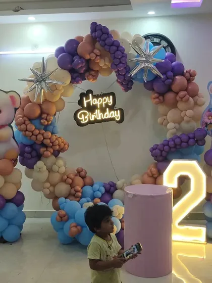 A cozy and cute Teddy Bear theme, perfect for a second birthday. This setup features a custom circular balloon arch in soft, gentle colors, paired with a large light-up number and adorable teddy bear props.