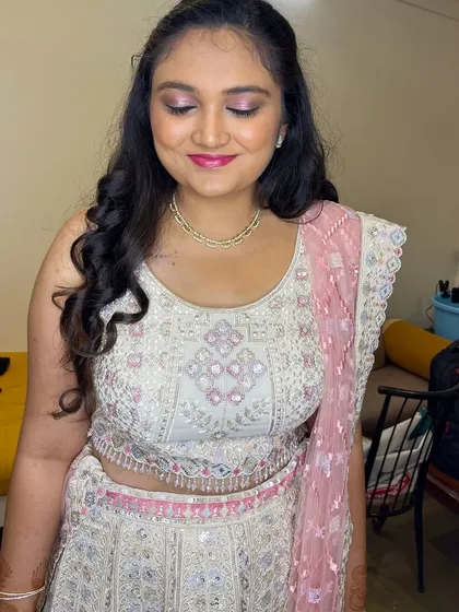 A detailed shot of Tiana's makeup. The pink and silver eyeshadow complements her lehenga perfectly, and her skin has a beautiful, dewy finish.