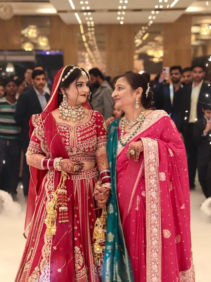 A precious moment between the bride and her mother. My bride Sheetal looks radiant in her red lehenga.