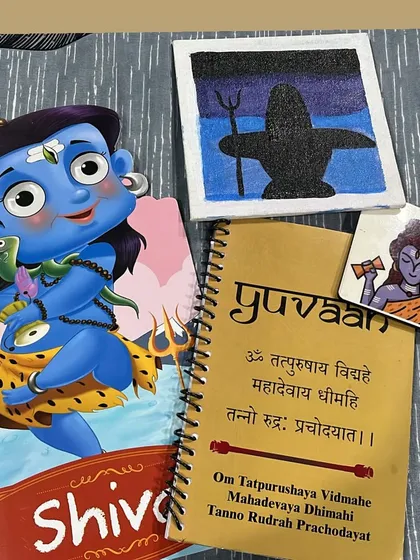 The takeaway kit from our Shiva workshop, including a storybook, a personalized notebook with a mantra, and a canvas for painting.