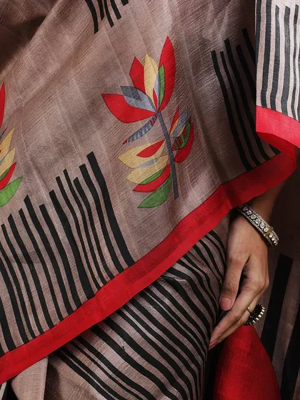A close-up of the colorful floral motif on the abstract printed saree, highlighting its artistic details.
