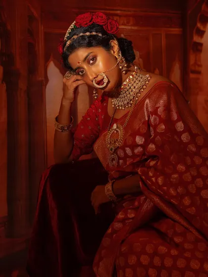 This editorial shoot with Ketaki Narayan was about creating a dramatic, artistic mood. I styled her in a deep red Banarsi silk saree with traditional jewellery and a floral hairpiece to evoke a sense of vintage, painterly beauty.