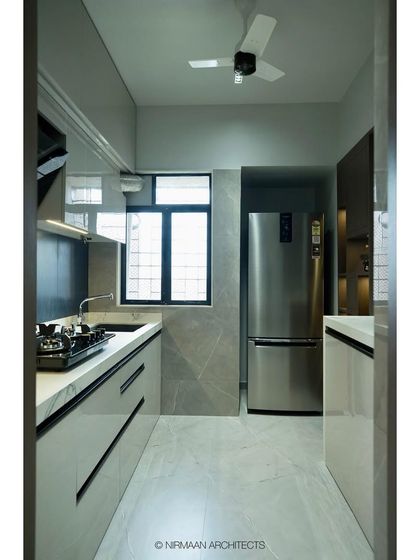 A full view of the galley kitchen at Tulsi Heights. The layout is designed for maximum efficiency, with everything within easy reach, while the finishes keep the space feeling bright and modern.