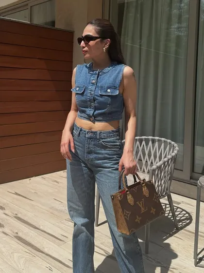 A sunny day look featuring a denim vest and relaxed-fit jeans. This is a great way to do denim-on-denim in the warmer months.