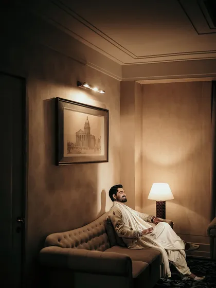 A quiet moment of reflection for the groom. I used the warm, ambient light of the room to create a moody and contemplative portrait before the evening's festivities.