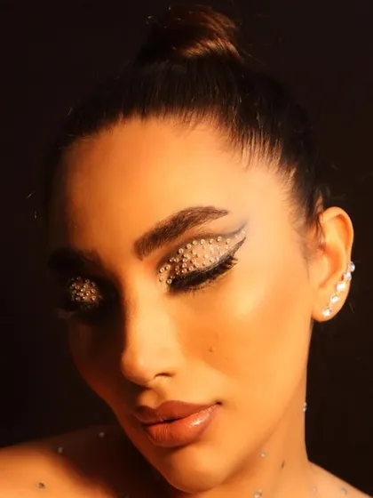 A close-up showcasing the intricate detail of a graphic rhinestone eye look. The sharp lines and sparkling texture create a futuristic and edgy vibe, perfect for a model's portfolio or a fashion-forward campaign.