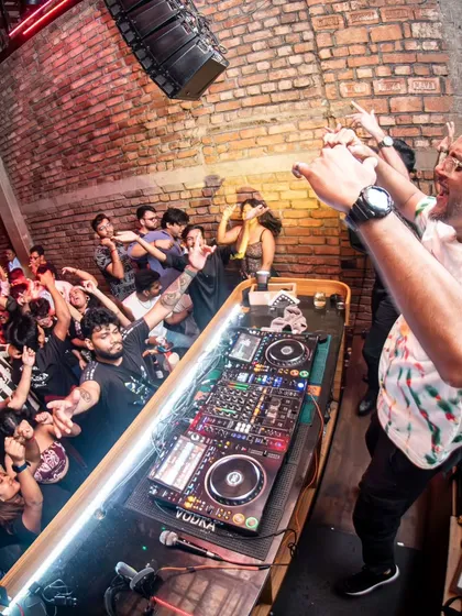 Leaning into the crowd at Roxy, Kolkata. I like to break the barrier between the stage and the dance floor to create a more connected experience.