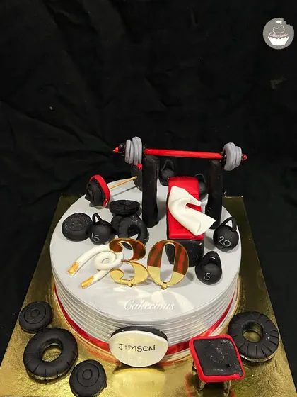I love a creative challenge, and this gym-themed cake was so much fun to make. It's perfect for the fitness enthusiast in your life, complete with fondant weights, a barbell, and other workout accessories, all on an eggless cake.