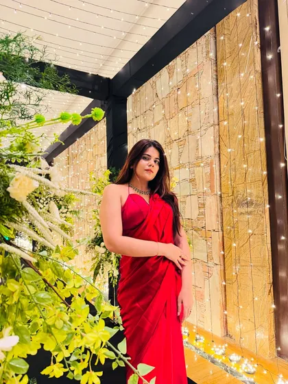 A direct shot showcasing the elegance of a red saree. This is a timeless look that never goes out of style for wedding events.