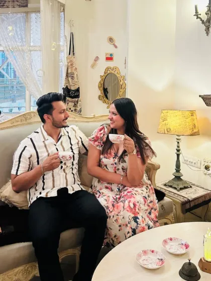 Vintage vibes and tea-time smiles. A couple enjoys a quiet moment together on our vintage sofa, sharing tea and conversation in the warm ambiance of the cafe.