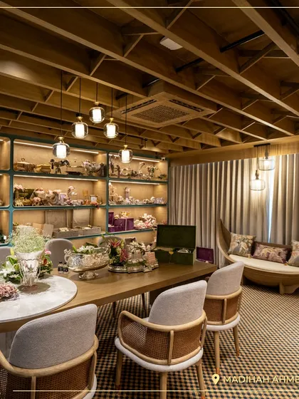 Another view of our Ahmedabad store's interior, featuring a unique boat-shaped sofa and beautifully lit display cases. The design of the store itself is meant to be an experience.