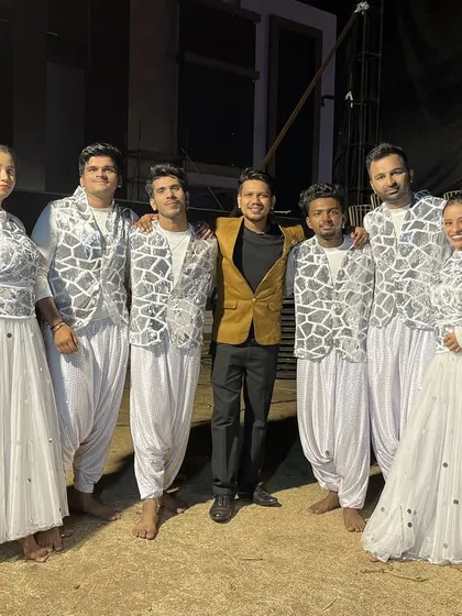 The team in elegant white and silver outfits, ready for another grand Sangeet performance. We coordinate costumes to match the theme of your event perfectly.
