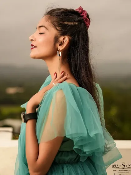 A serene profile shot with the model's eyes closed, enjoying a moment of peace on the rooftop.