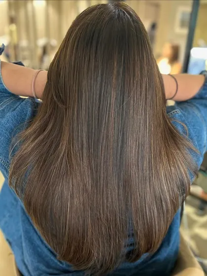 This warm three-tone highlight blend looks fantastic styled straight. It allows you to see every detail of the blended color on this classic long haircut.
