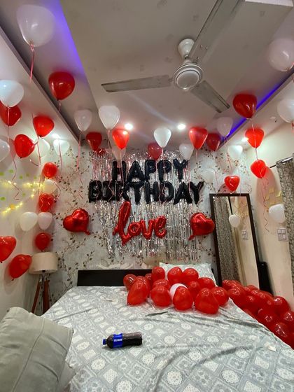 A wider angle of the red, white, and black themed birthday room. You can see how the balloons fill the space, creating an immersive and festive environment from the moment your loved one walks in.