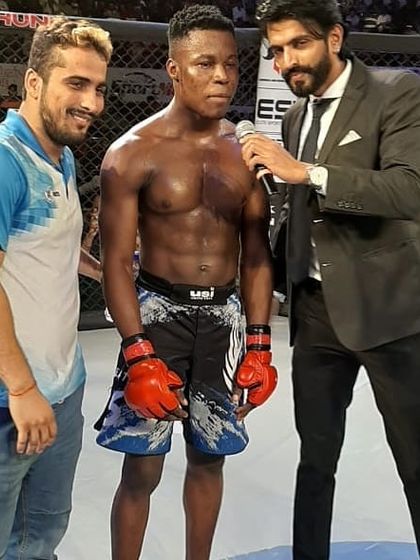 Our superstar fighter Justin Kennedy after a professional MMA win, being interviewed in the cage.