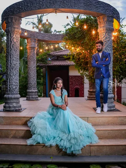 A stylish couple poses at our stone gazebo at dusk, with the lights just beginning to glow.