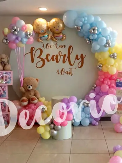 A fun and colorful baby shower setup that has it all: a "We Can Bearly Wait" backdrop, pastel rainbow balloons, teddy bears, and even a unicorn foil balloon. This shows how I can combine different elements for a truly unique party.