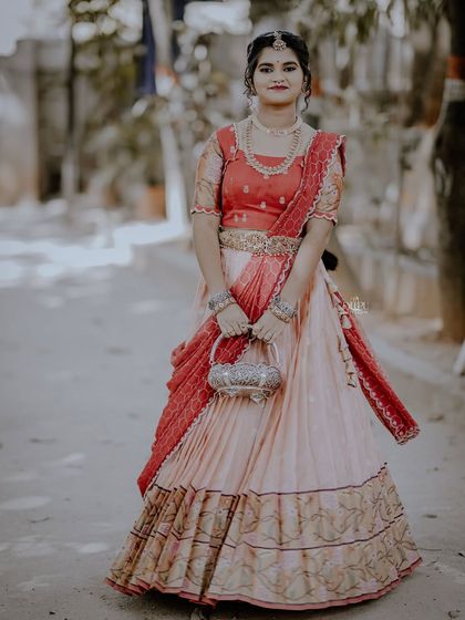 For the Makara Sankranthi festival, I designed this exquisite Zari Kota lehenga for my client. The peach skirt with a traditional border is paired with a red brocade blouse, creating a vision of grace and tradition.