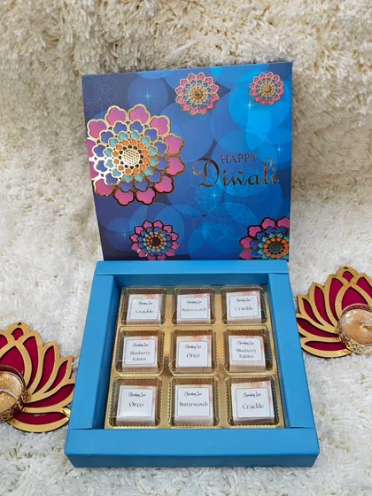 A simple yet elegant Diwali gift: a box of nine assorted handmade chocolates paired with two lotus-shaped diyas.
