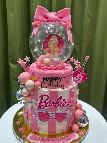 For the ultimate Barbie fan, I designed this two-tier glam cake. It’s all about the pink, the sparkle, and the fun details, including a light-up globe topper. This is the kind of showstopper I love creating for kids' birthdays.