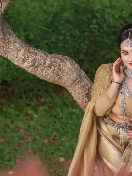 A collection of portraits featuring a model in a golden-hued traditional outfit, shot outdoors. The natural light and garden setting add a soft, ethereal quality to these elegant images.