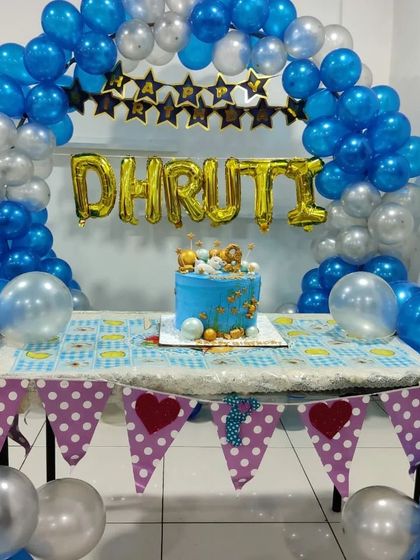 A beautifully decorated cake table set up for Dhruti's birthday celebration. I can help coordinate the space to match your theme.