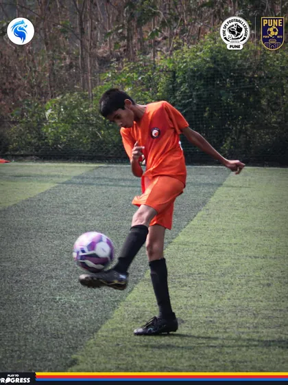 A young player in Pune practices his ball control. The journey to excellence starts with mastering the fundamentals.