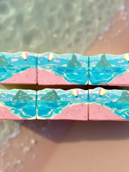 A flat lay of my Pink Sands beach soap, showing how the design looks across multiple bars. The swirling blues and textured pink sand create a beautiful coastal scene.
