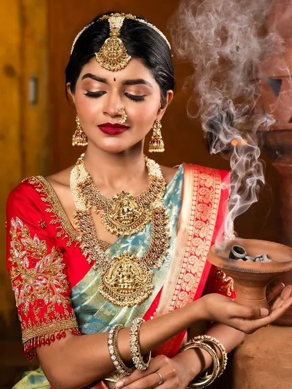 This is the essence of a South Indian bridal look. I focused on creating a flawless, radiant base with bold, expressive eyes and classic red lips, ensuring my bride looked timeless and divine.