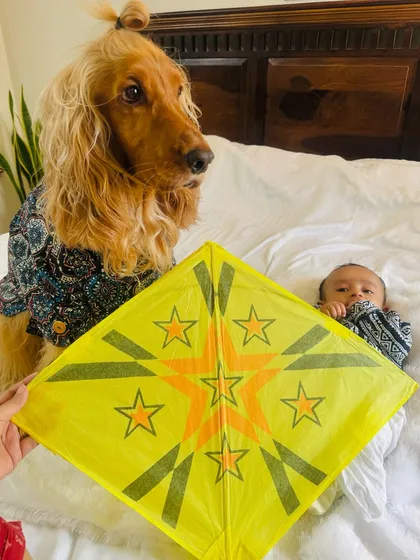 Posto and Pablo posing with a colorful kite for the festival.