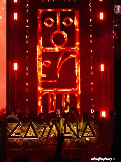 The massive, intricate stage design for Zamna Festival, glowing red. This shot highlights the incredible production value of the electronic music events I cover.