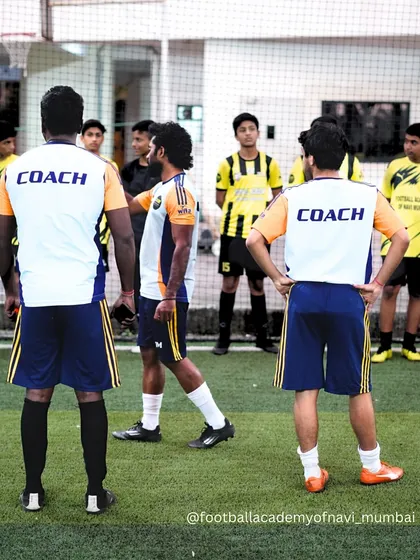 Our coaching staff discussing strategy and planning for the training session. This collaborative approach ensures a high-quality experience for our players.