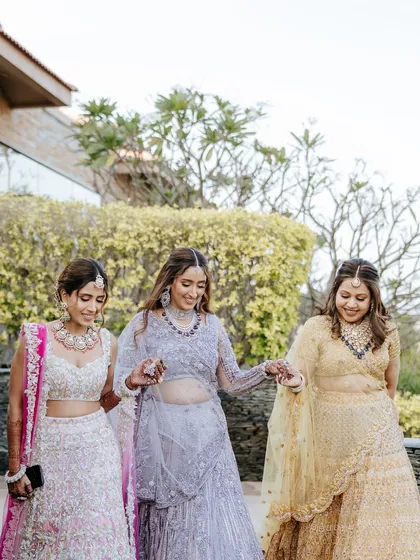 The bride walks with her bridesmaids, sharing a happy, relaxed moment before the ceremony. We believe in creating a stress-free environment where these bonds can be cherished.
