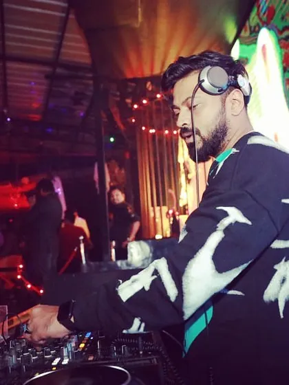 A candid shot of me focused on the Pioneer decks during a set at Bombay Adda. This is where the magic happens.