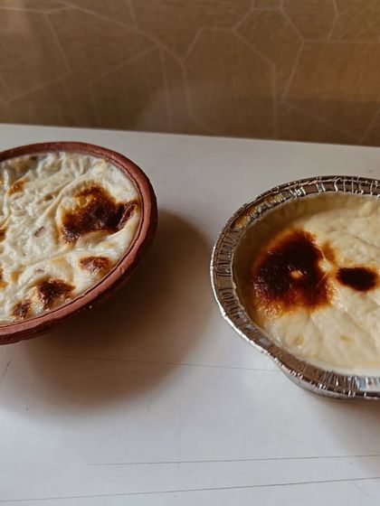 My Baked Phirni, served in both a traditional clay pot and a modern foil container. The flavour is what matters, no matter how it's served.