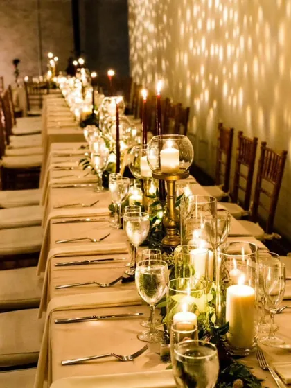There is nothing quite like the warm glow of candlelight to bring people together. This long table setup creates an incredibly intimate and inviting atmosphere, perfect for a fine dining experience with close friends and family.