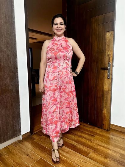 A closer look at the pink floral chiffon coord set. The halter neck and straight pants create a very modern and chic silhouette.