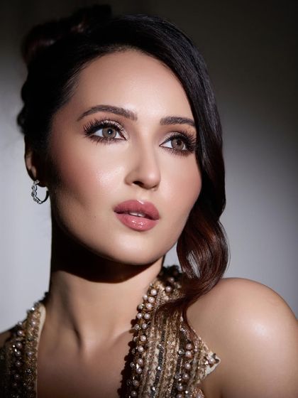 A close-up of a client ready for her Bridgerton-inspired cocktail night. I styled her hair in a soft, romantic updo with a side part and gentle waves framing her face, giving her a regal and elegant look.