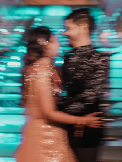 A creative motion blur shot of the couple on the dance floor. This artistic photo conveys the movement and dynamic energy of the reception party.