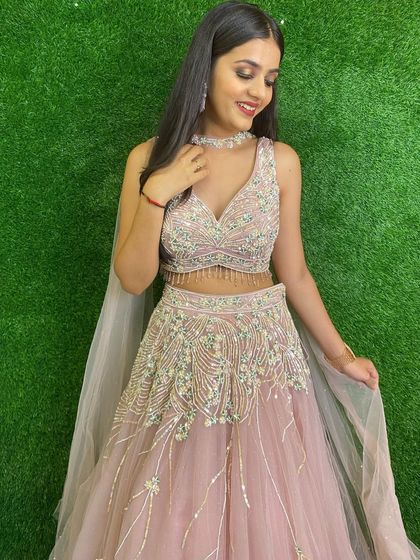 A client looking lovely in our pastel pink lehenga with delicate, cascading embroidery. It's a soft, romantic, and very popular choice for engagements.